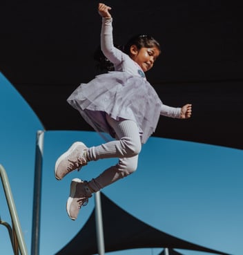 A child at a kindergarten leaping