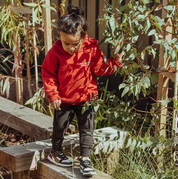 A child plays in an outdoor kindergarten setting