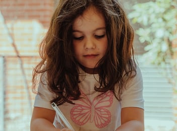 A child writing in kindergarten