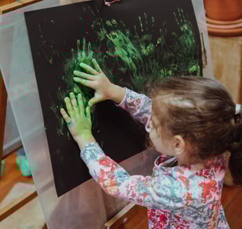 a child does finger painting