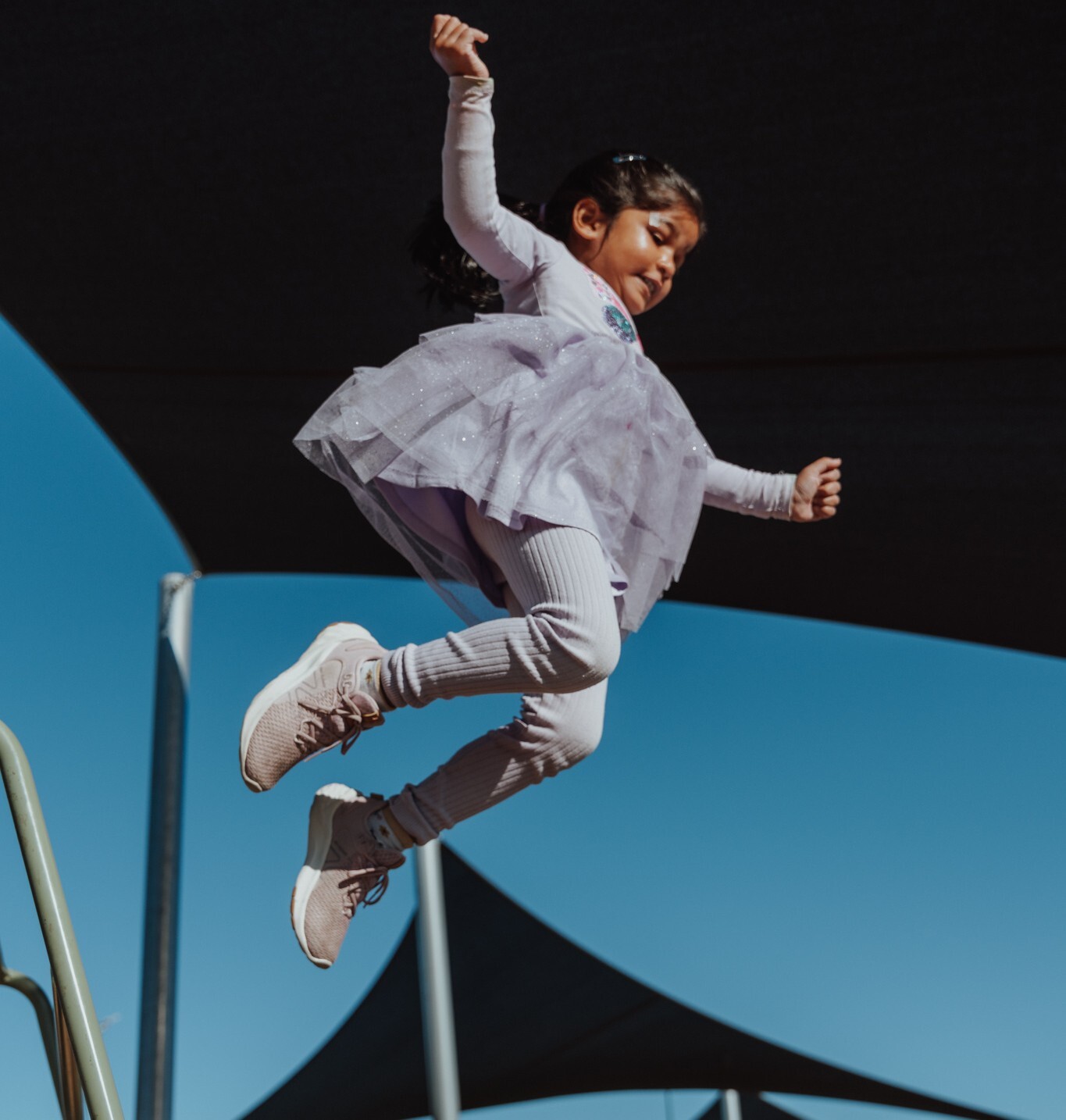 A child at a kindergarten leaping