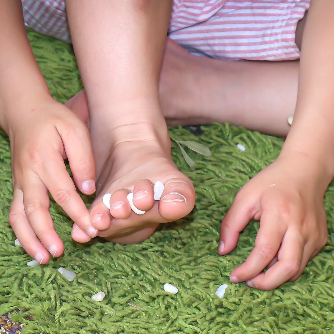 A child with bare feet playing in a kindergarten