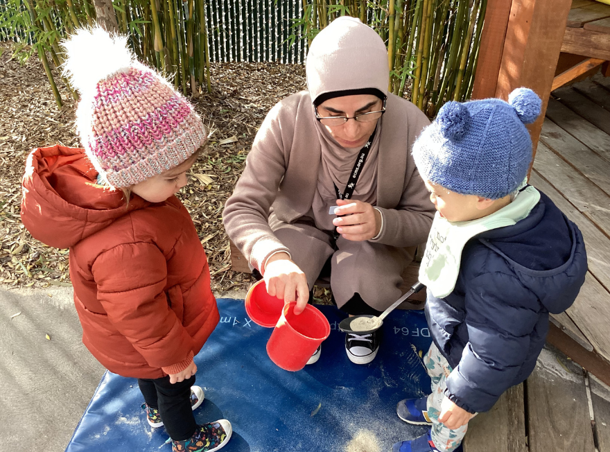 A teacher at Maribyrnong River Children's Centre with two children