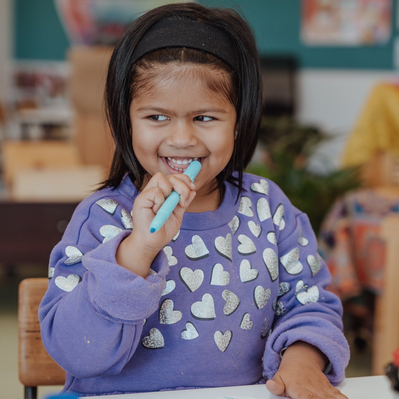 A child at a kindergarten smiling